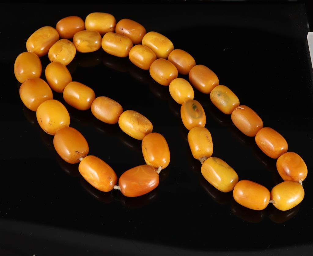 A single strand oval amber bead necklace, 74cm, gross weight 128 grams,